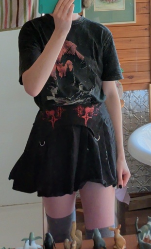 Women in a black and red skirt with a t shirt with a dragon on it
