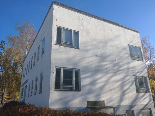 A square white house in the autumn sun