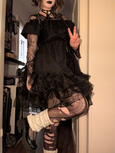 Me in a knee length Gothic Lolita dress with black ripped tights, leg warmers and mary janes